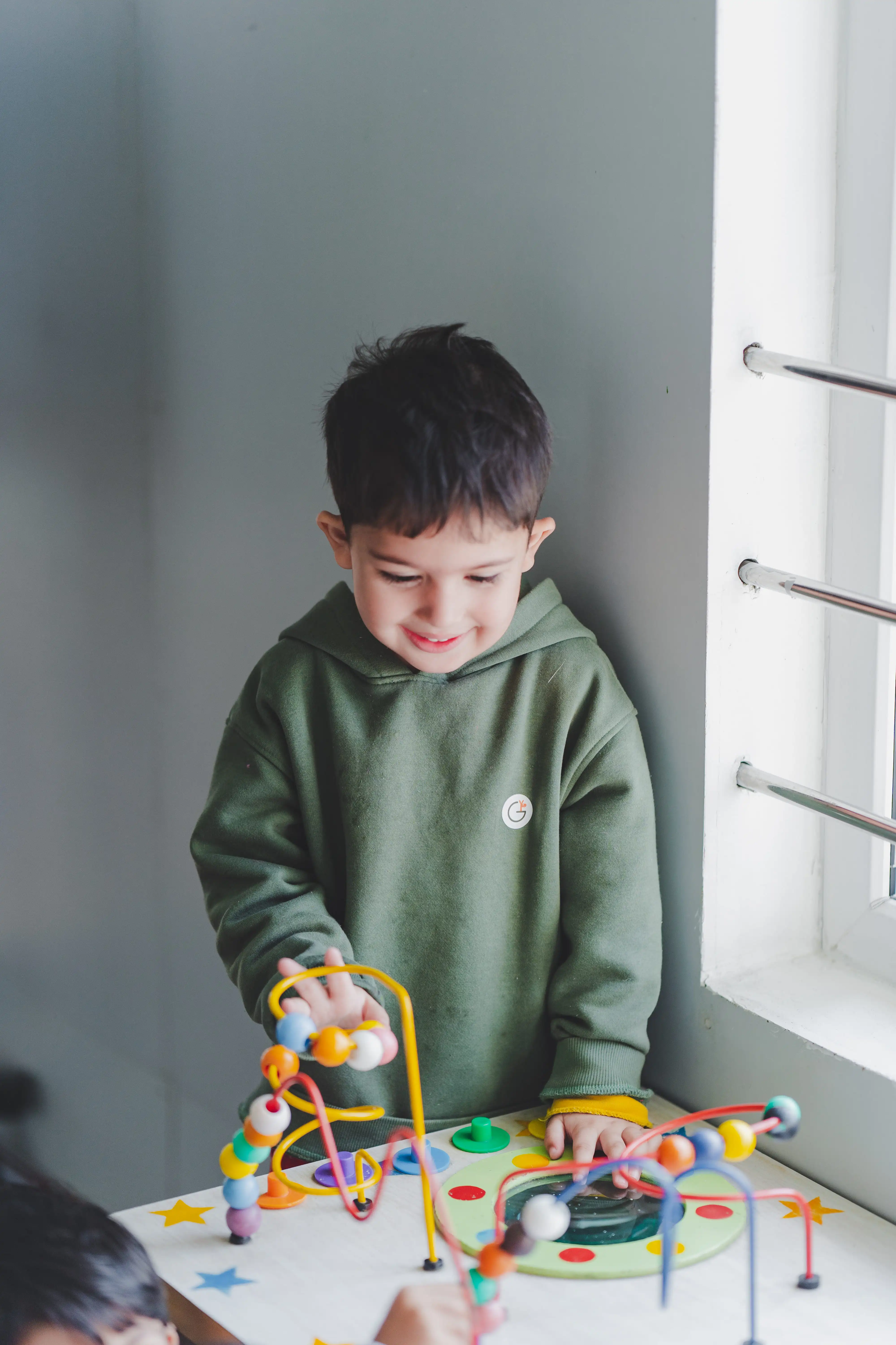 A child exploring our carefully designed play area, showcasing our nurturing learning environment