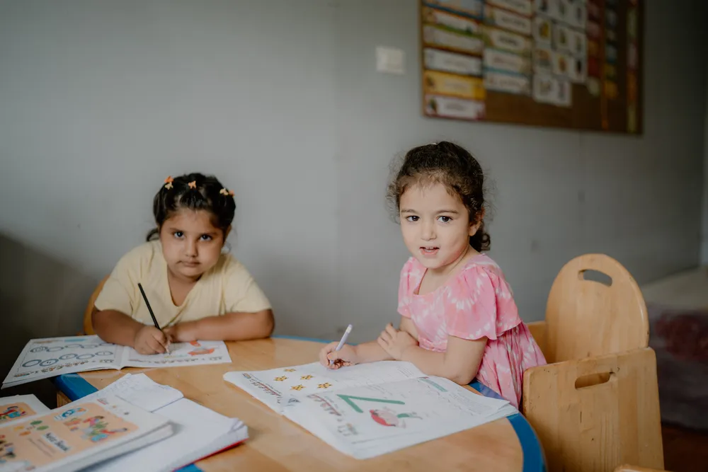 Two children learning together at a table